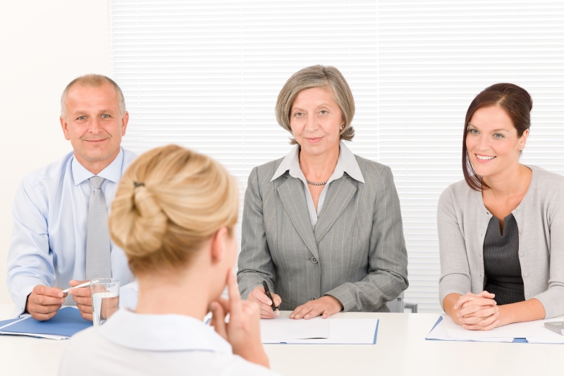 2402151-job-interview-young-woman-with-business-team